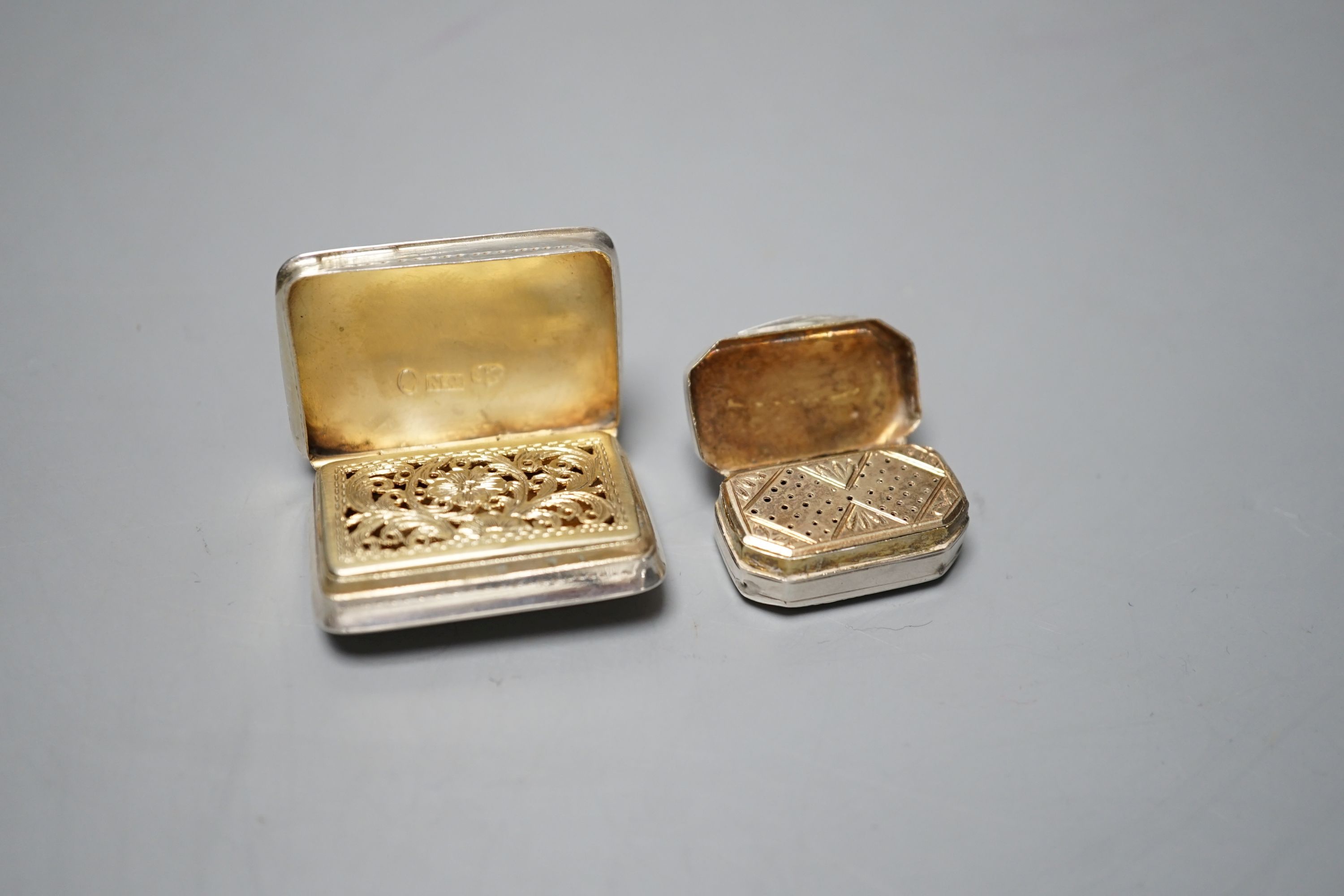 A William IV silver rectangular vinaigrette by Nathaniel Mills, Birmingham, 1836, with engraved decoration and initials, 35mm and one other earlier smaller vinaigrette, maker W?, London, 1813, 12mm.